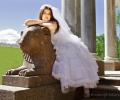 Невеста позирует фотографу на фигуре гранитного льва, охраняющего Воронихинские колоннады Петергофа